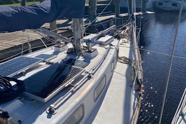 Tartan 34 1973 Tartan 34 sailboat with solar panels docked at a marina.