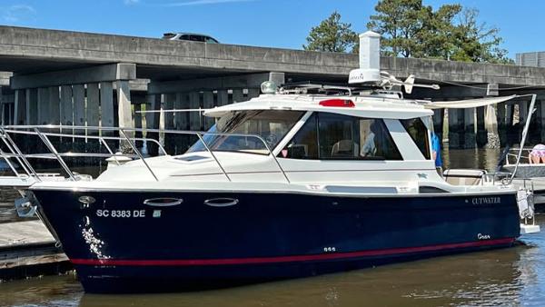 Cutwater C-26 2016 Cutwater C-26 boat docked near a bridge on a sunny day.