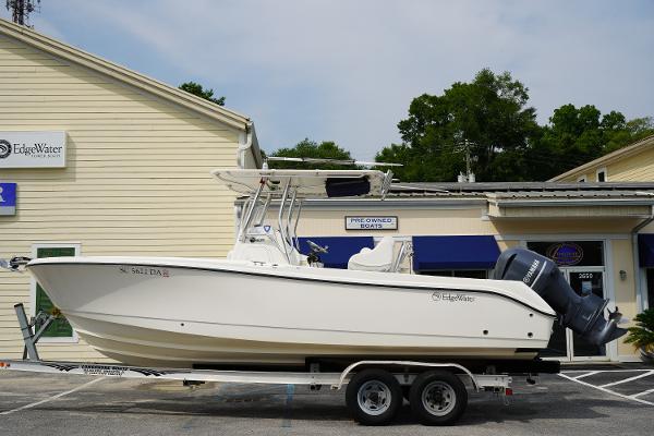 Edgewater 245CC 2014 Edgewater 245CC boat on trailer, parked outside a building.