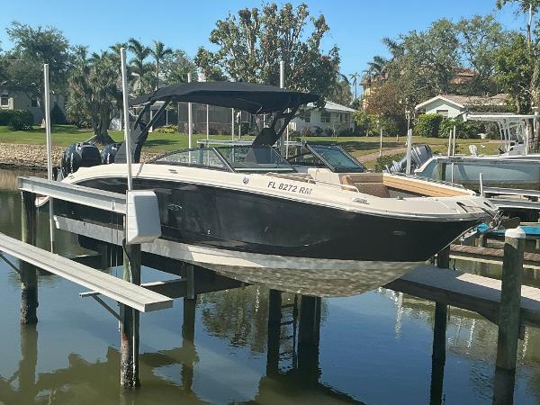 Sea Ray SDX 290 Outboard 2018 Sea Ray SDX 290 Outboard boat docked on a lift by the water.