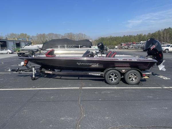 Phoenix 921 ELITE 2023 Phoenix 921 ELITE bass boat on a trailer in a parking lot.