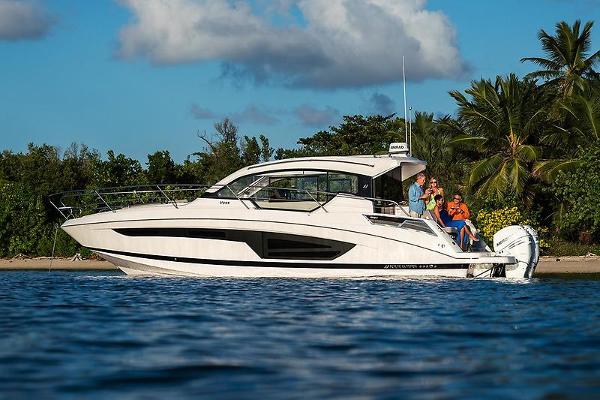 Four Winns Vista 355 Coupe 2021 Four Winns Vista 355 Coupe cruising near tropical shoreline.