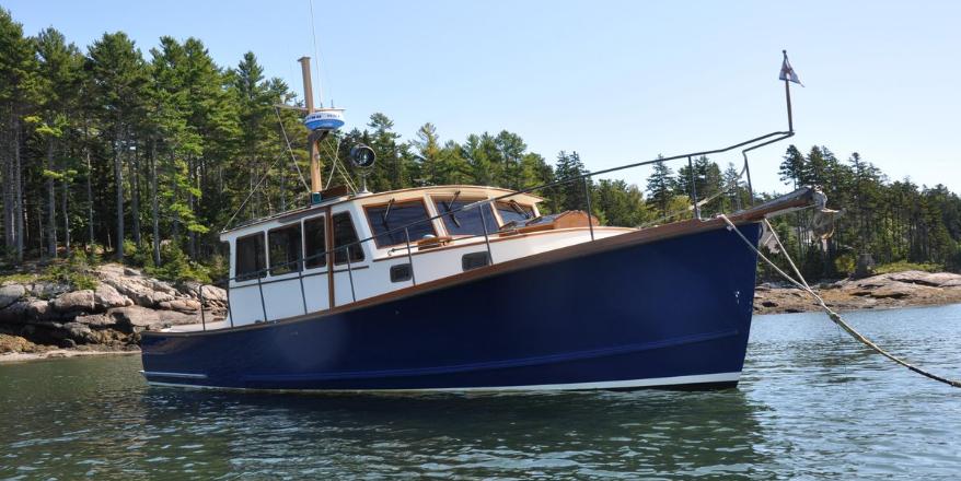 ShearWater 38 2003 ShearWater 38 boat anchored in scenic forested bay.