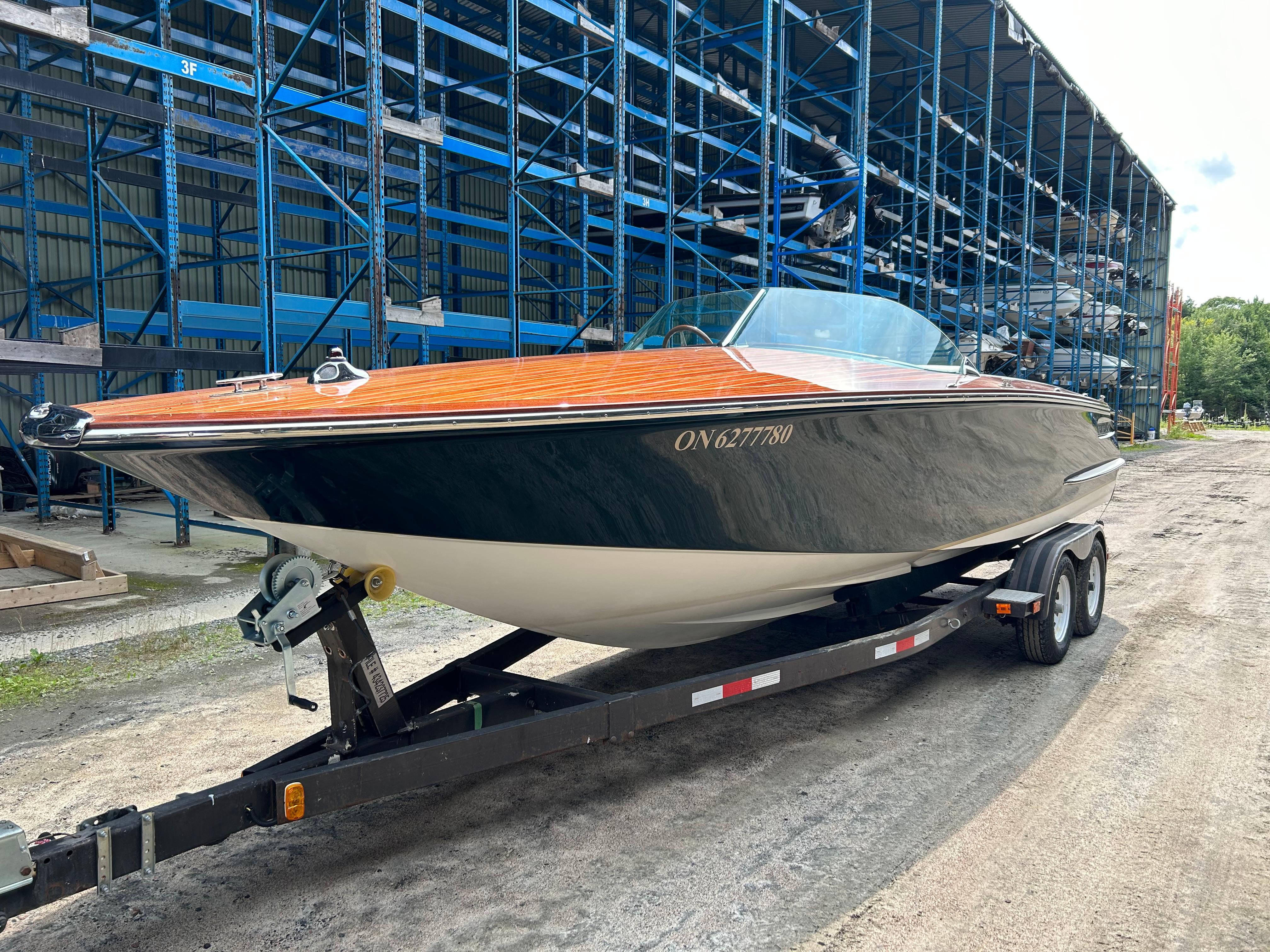 Kavalk 25 Belmaris 2018 Kavalk 25 Belmaris boat on trailer, parked near storage racks.