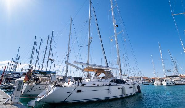 Oyster 53 Sailing yacht Oyster 53, 2007 model, docked in a marina under clear blue skies.