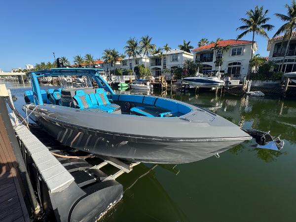Midnight Express 37 Open 2021 Midnight Express 37 Open boat docked in a scenic waterfront area with palm trees.