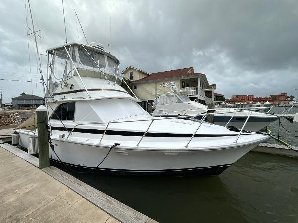 Bertram 35 Flybridge Sportfish 1978 Bertram 35 Flybridge Sportfish boat docked at marina under cloudy skies.