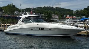 Sea Ray 44 Sundancer 2007 Sea Ray 44 Sundancer yacht docked at a marina with scenic background.