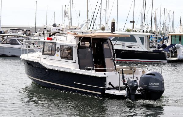 Ranger Tugs R-23 2019 Ranger Tugs R-23 boat docked in a marina with Yamaha outboard motor.