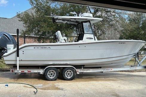 Cobia 280 Center Console 2023 Cobia 280 Center Console boat on trailer, parked outdoors.