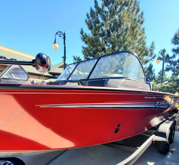 Tracker Targa V-19 WT 2024 Tracker Targa V-19 WT red boat on trailer, side view.