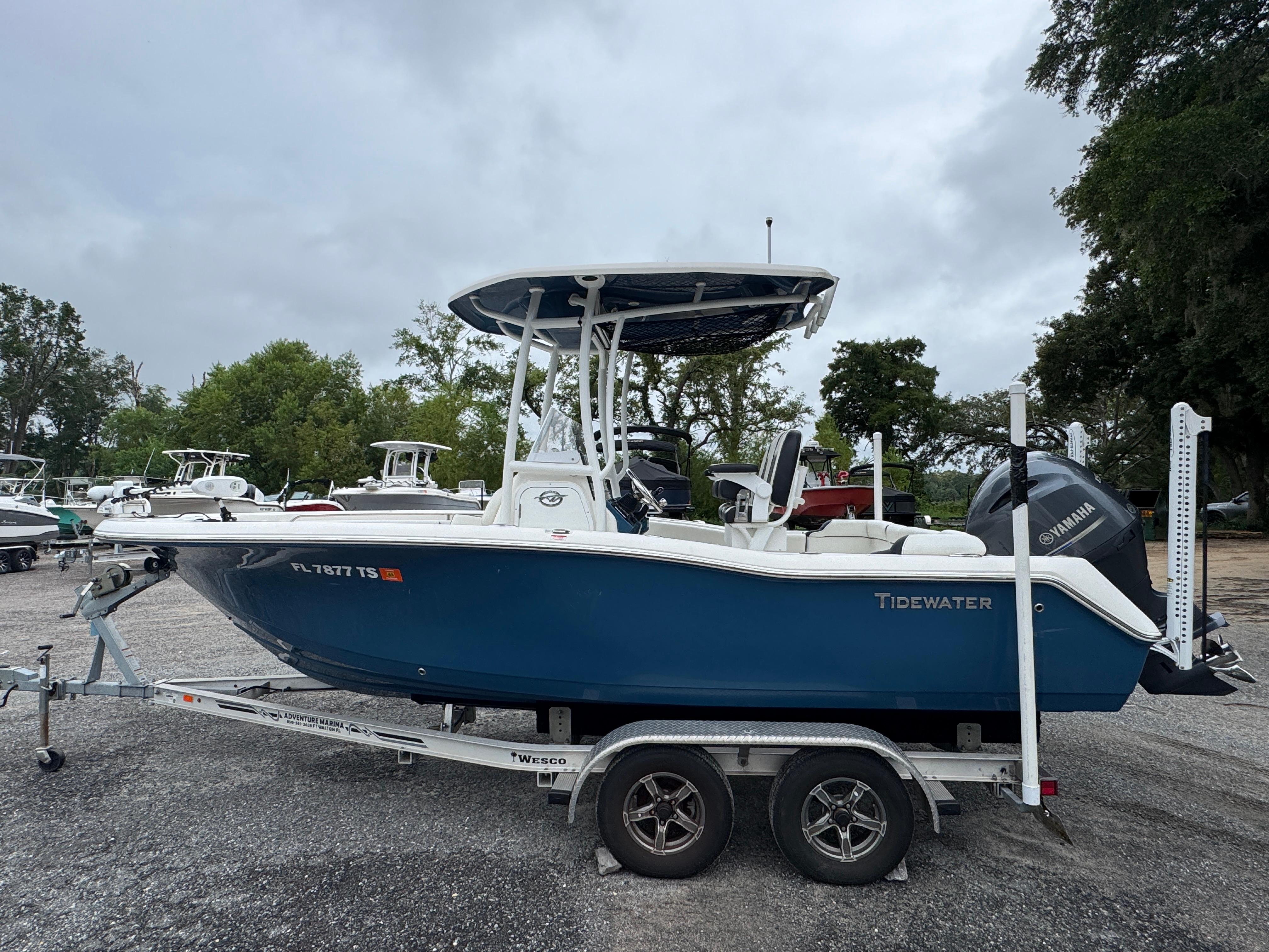Tidewater 210 LXF 2023 Tidewater 210 LXF boat on trailer, blue hull, parked outdoors.
