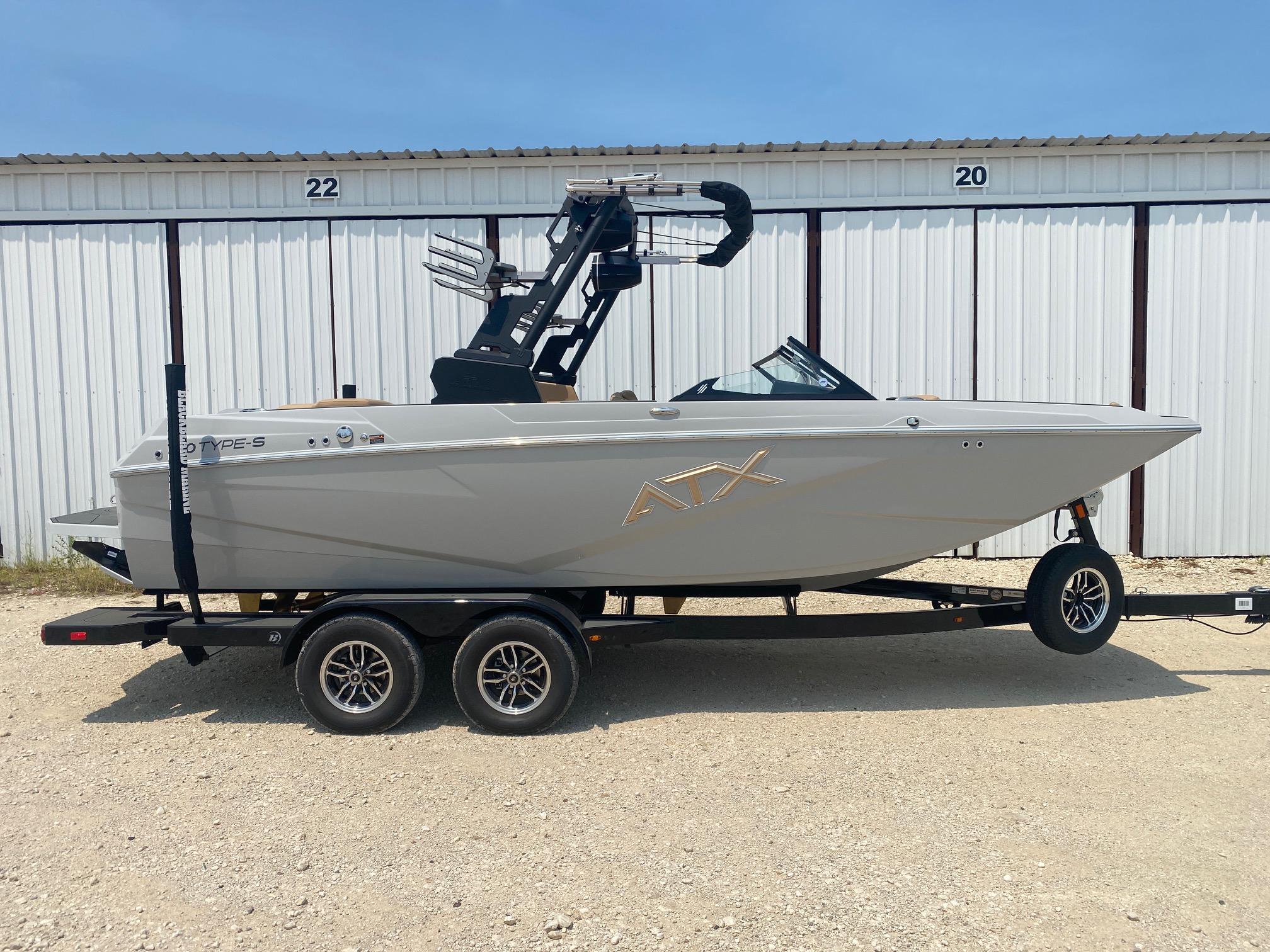 ATX Surf Boats 20 Type-S 2026 ATX Surf Boats 20 Type-S on trailer, parked outside storage units.