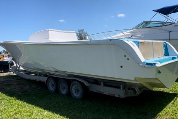 Streamline 45 2026 Streamline 45 boat on trailer, parked on grass under clear sky.