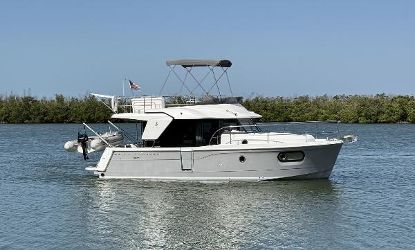 Beneteau Swift Trawler 30 2016 Beneteau Swift Trawler 30 cruising on calm waters with clear blue sky.