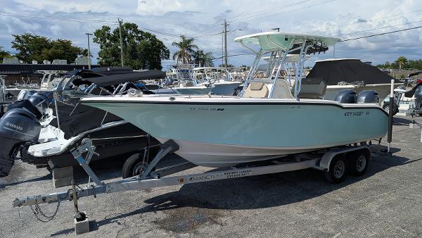Key West 244 Center Console 2022 Key West 244 Center Console boat on trailer in marina setting.