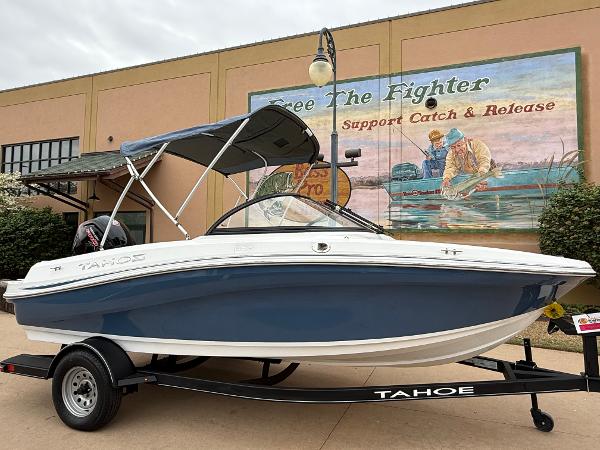 Tahoe 185 S 2023 Tahoe 185 S boat on trailer, blue and white design, parked outdoors.