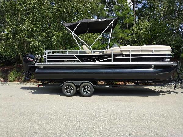 Ranger Reata 223FC 2024 Ranger Reata 223FC pontoon boat with canopy on trailer, parked outdoors.