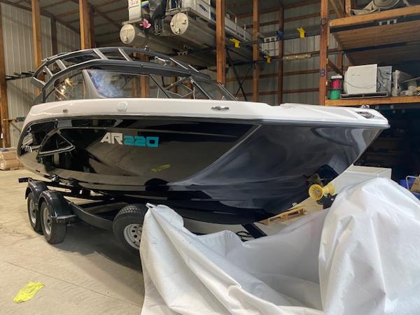 Yamaha Boats AR220 2025 Yamaha Boats AR220 in storage, sleek black design on a trailer.