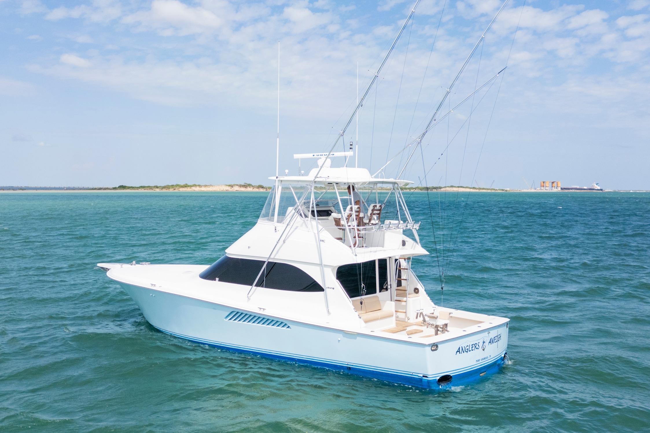 Viking 50 Convertible 2009 Viking 50 Convertible yacht on open water, clear sky, distant shoreline.