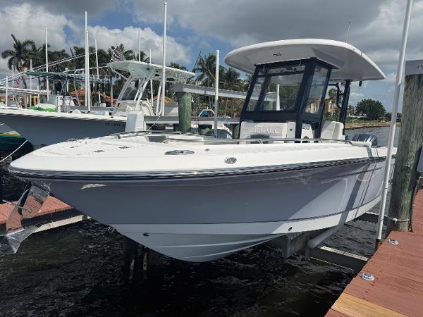 Robalo R272 Center Console 2023 Robalo R272 Center Console boat docked at marina under cloudy sky.
