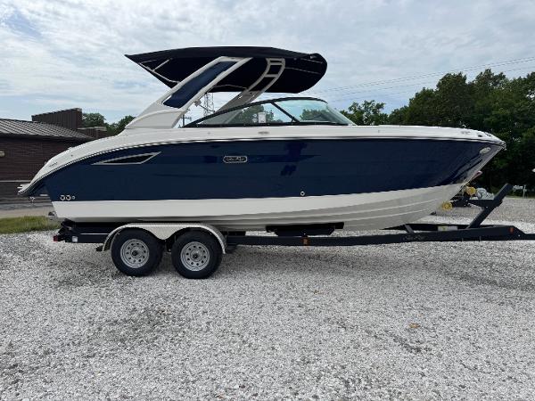 Sea Ray SDX 250 2025 Sea Ray SDX 250 boat on trailer, blue and white design, parked outdoors.