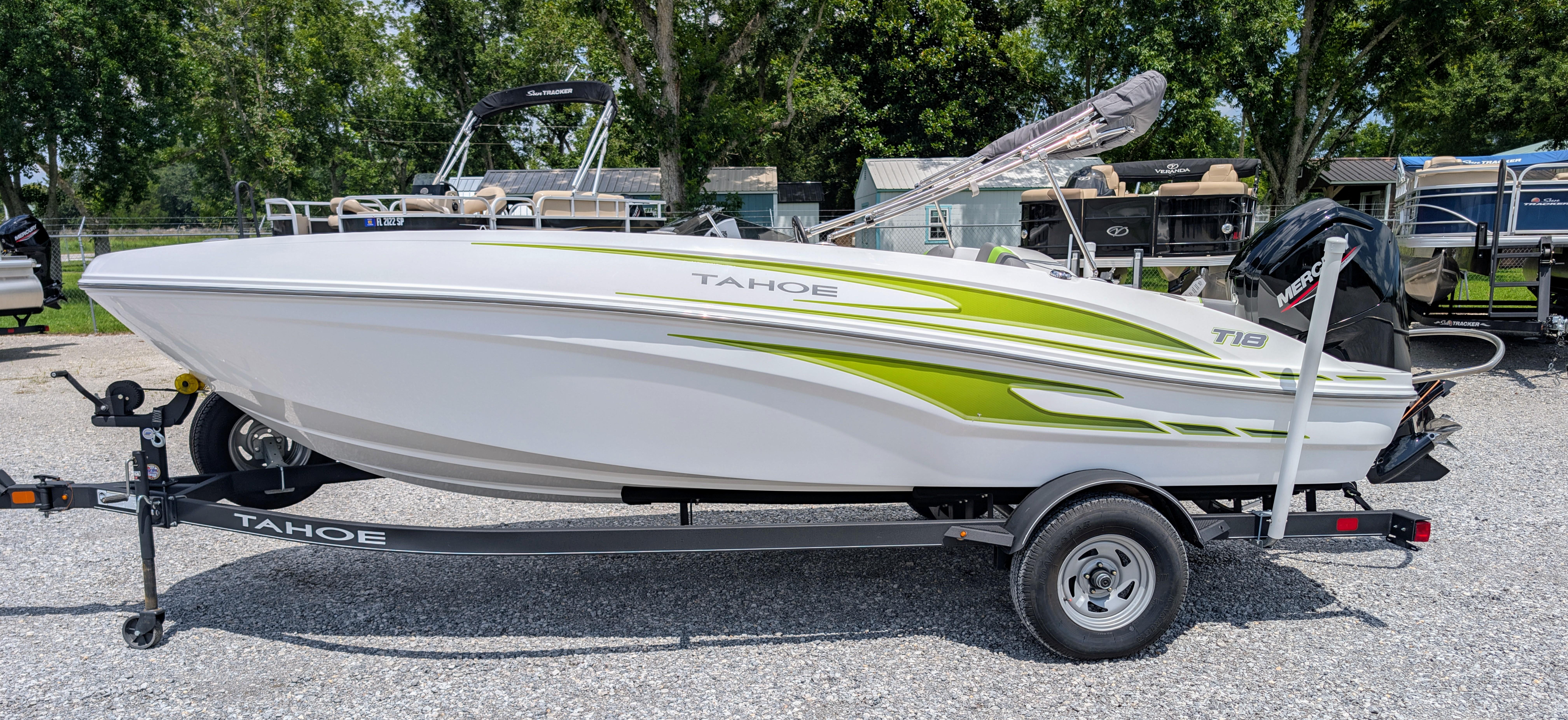 Tahoe T18 2023 Tahoe T18 boat on trailer, white with green accents, parked outdoors.