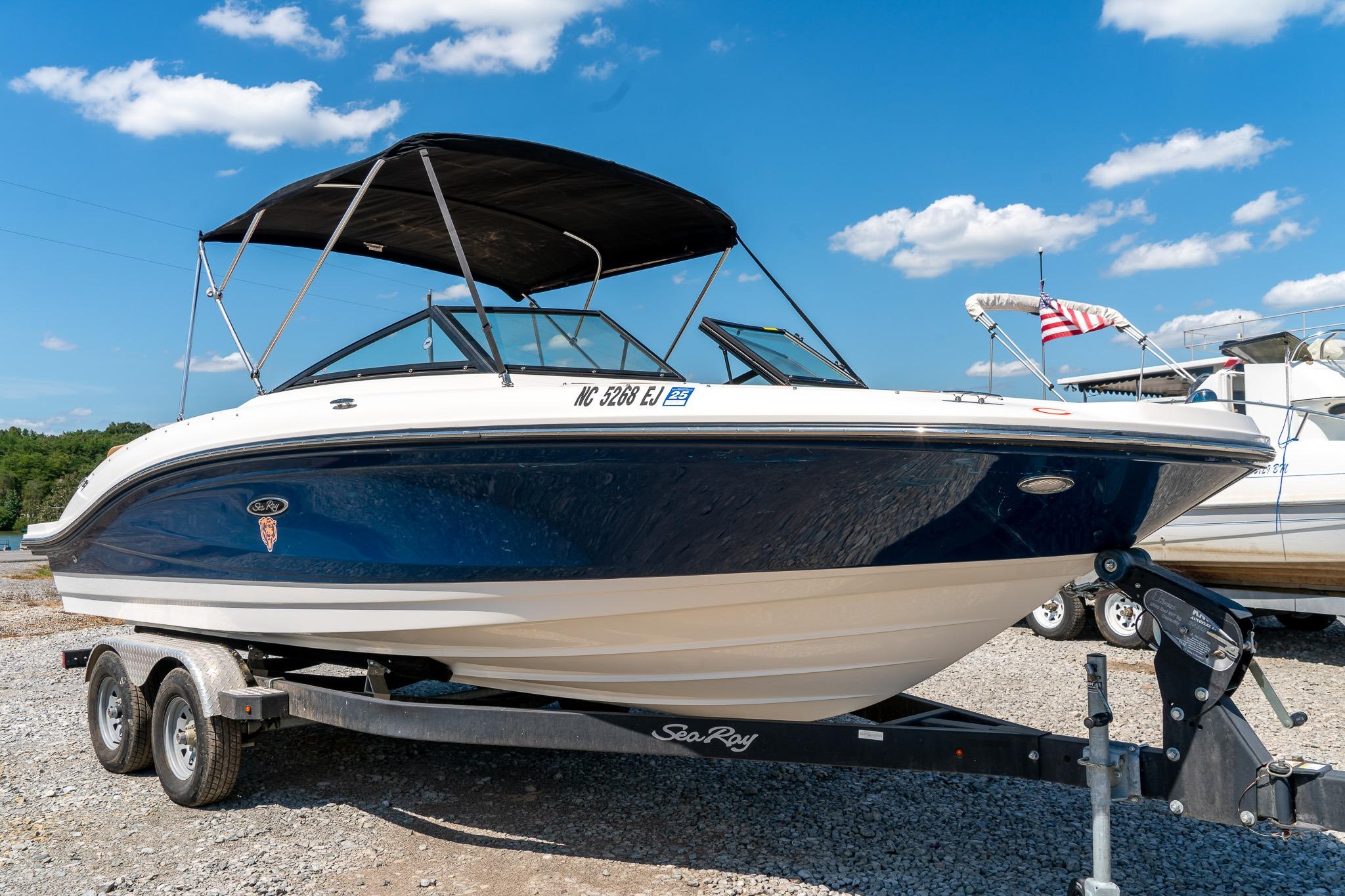 Sea Ray SPX 210 2018 Sea Ray SPX 210 boat on trailer under clear blue sky.