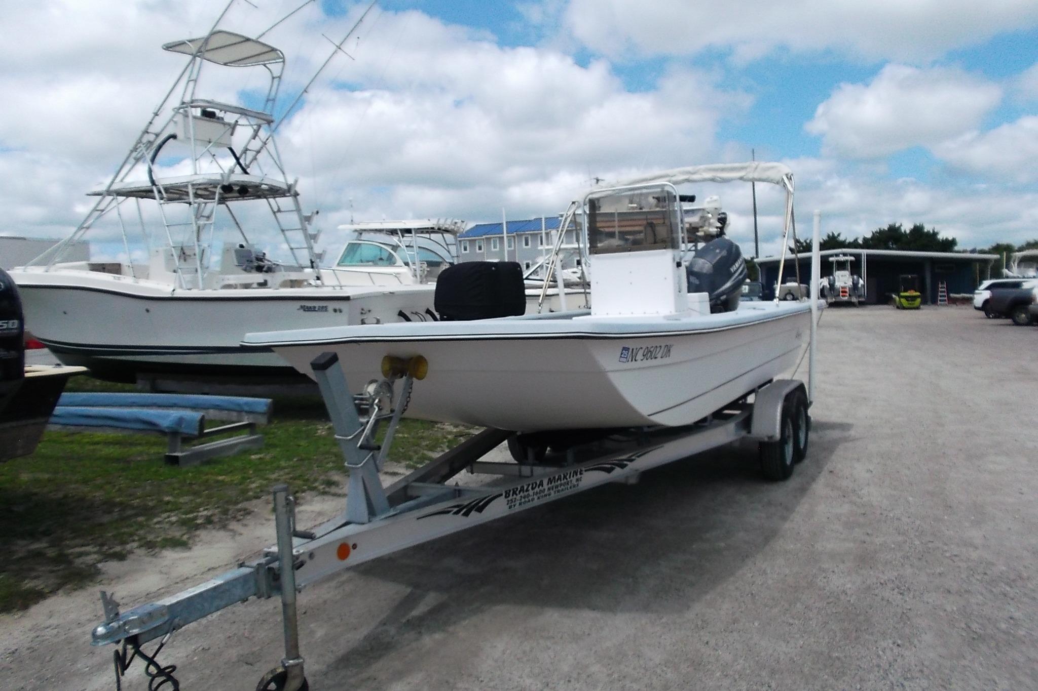 Hancock 22 2008 Hancock 22 boat on trailer in a marina, with other boats in the background.