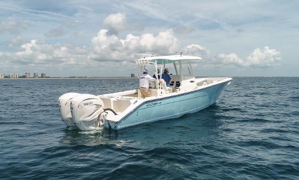 Cobia 320 CC 2024 Cobia 320 CC boat on open water with twin Yamaha engines.