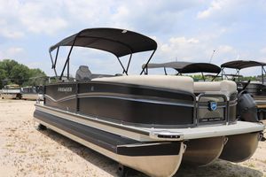 Premier 250 Solaris Rev 2024 Premier 250 Solaris Rev pontoon boat with canopy, parked on sandy terrain.