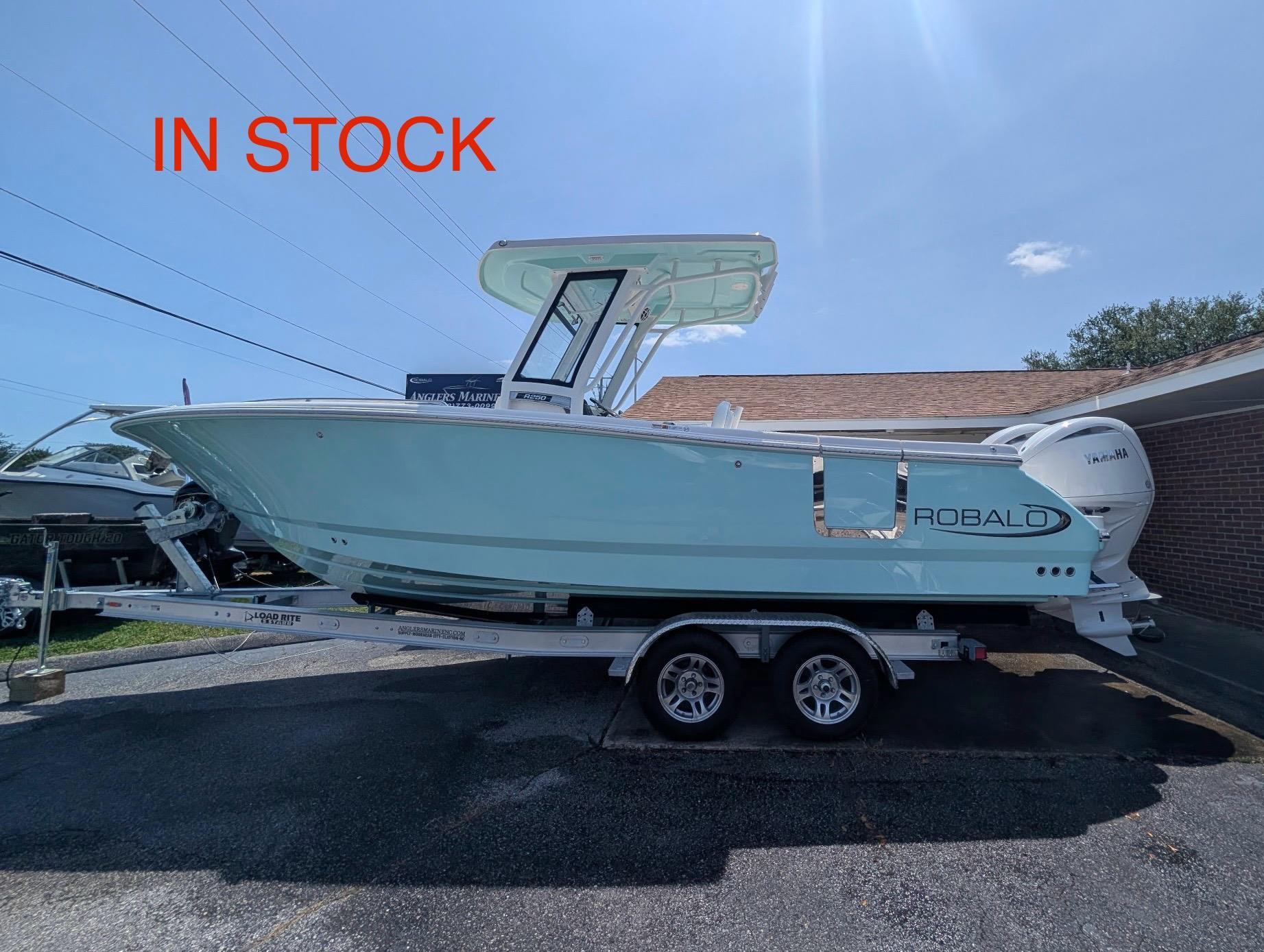 Robalo R250 Center Console 2025 Robalo R250 Center Console boat on trailer, in stock, sunny day.