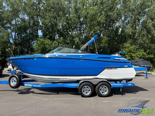 Monterey 258 Super Sport 2018 Monterey 258 Super Sport boat in vibrant blue on a trailer, parked outdoors.