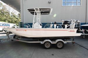 Boston Whaler 190 Montauk 2023 Boston Whaler 190 Montauk boat on trailer, parked outdoors near industrial building.