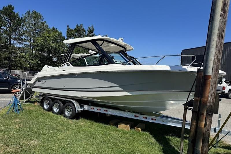 Boston Whaler 280 Vantage 2025 Boston Whaler 280 Vantage boat on trailer, parked outdoors on grass.