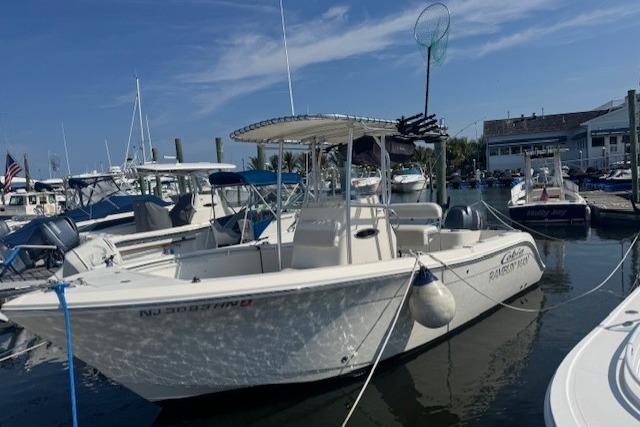 Cobia 217 Center Console 2014 Cobia 217 Center Console boat docked in a marina under a clear blue sky.