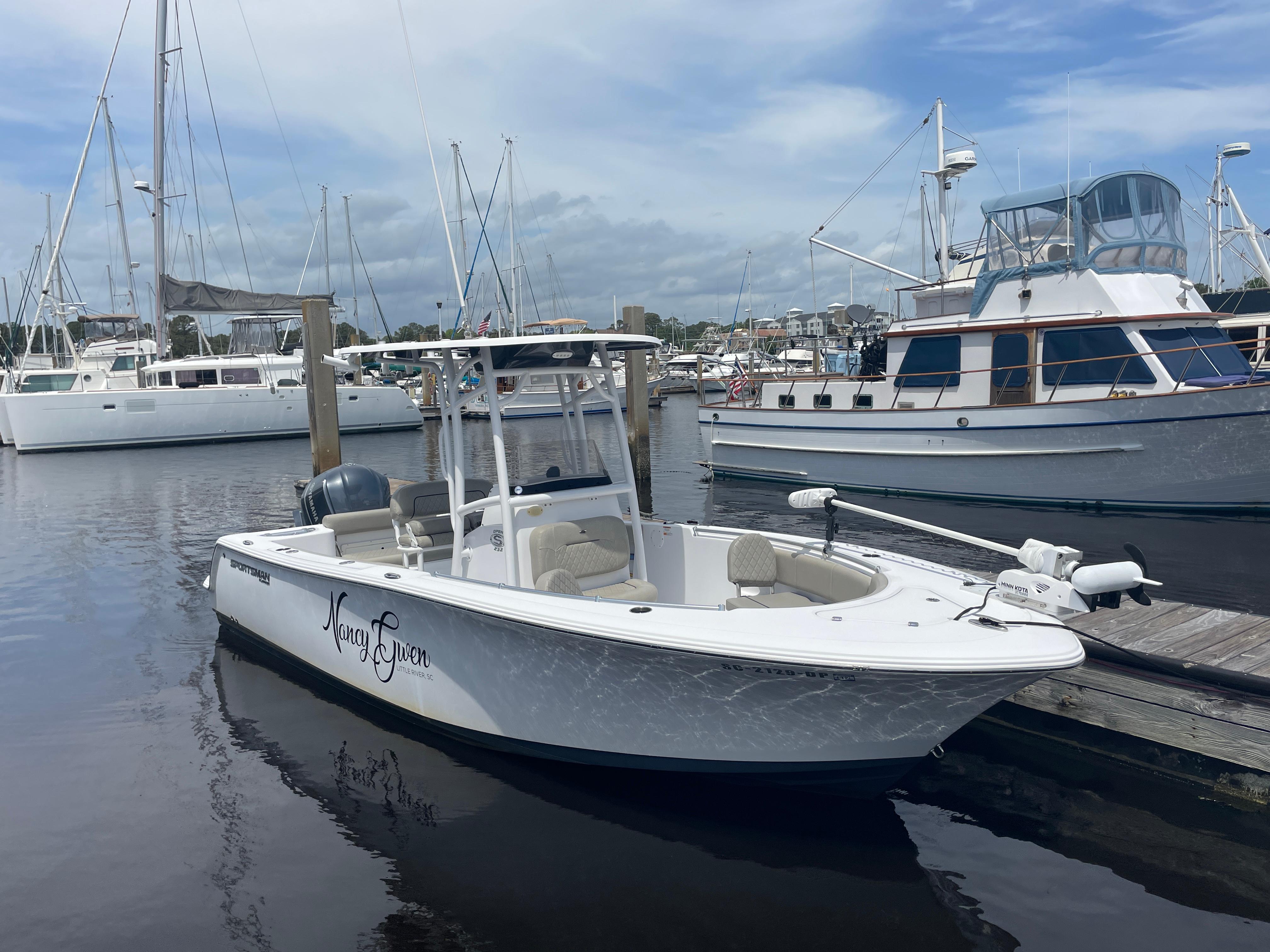 Sportsman 232 2021 Sportsman 232 boat docked in a marina with other vessels.