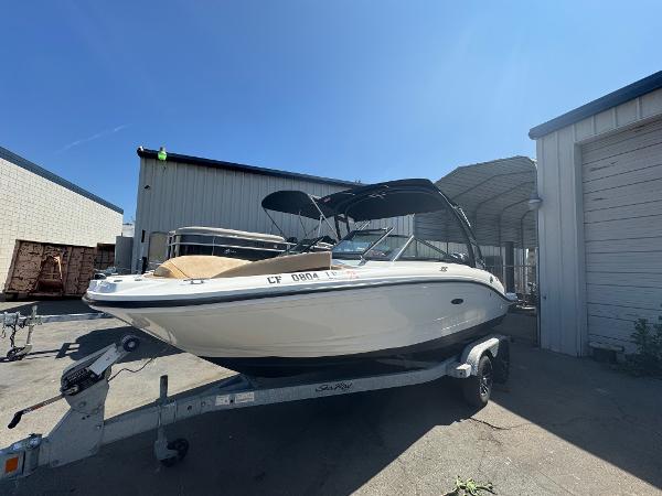 Sea Ray SPX 190 Outboard 2023 Sea Ray SPX 190 OB boat on trailer, parked outdoors under clear blue sky.