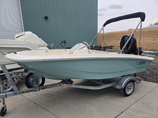 Boston Whaler 130 Super Sport 2025 Boston Whaler 130 Super Sport boat on trailer, parked outdoors.
