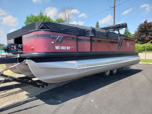 Viaggio 20F 2022 Viaggio 20F pontoon boat on trailer, parked outdoors under clear sky.