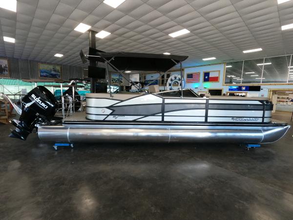 Vanderbilt 700T 2023 Vanderbilt 700T pontoon boat in showroom with Suzuki outboard motor.