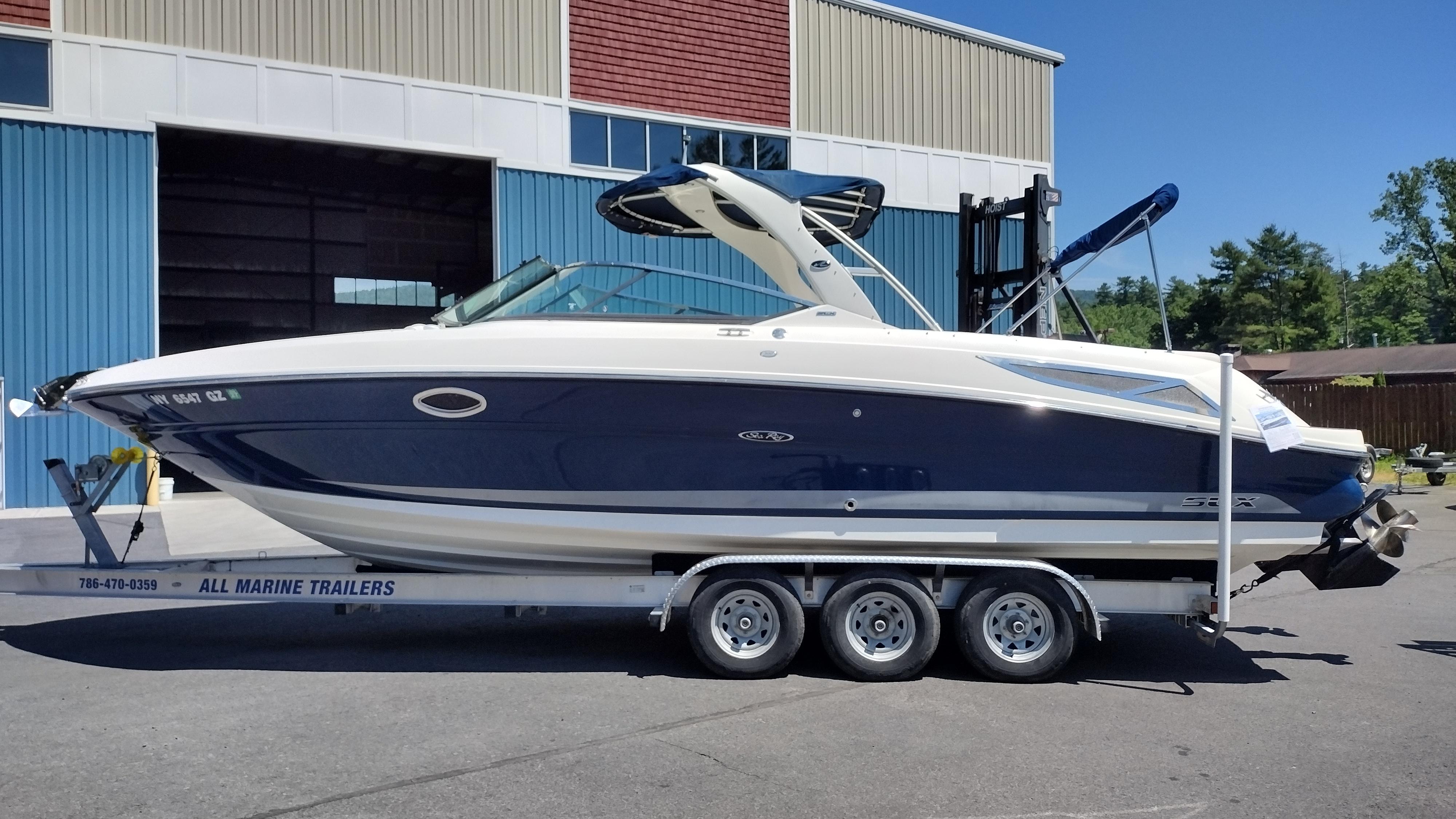 Sea Ray 300 SLX 2010 Sea Ray 300 SLX boat on trailer, parked outside a warehouse.