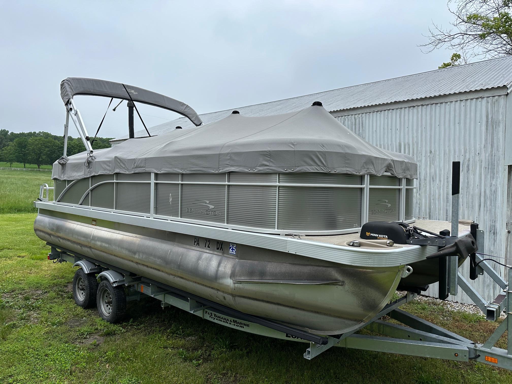 Bennington 22 SSR Quad Bench with Yamaha 25Hp & Tandem axle Trailer 2019 Bennington 22 SSR Quad Bench pontoon boat on trailer, covered and parked outdoors.