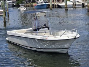 Shamrock 246 Open 1999 Shamrock 246 Open boat cruising in a marina, featuring a sleek white design.