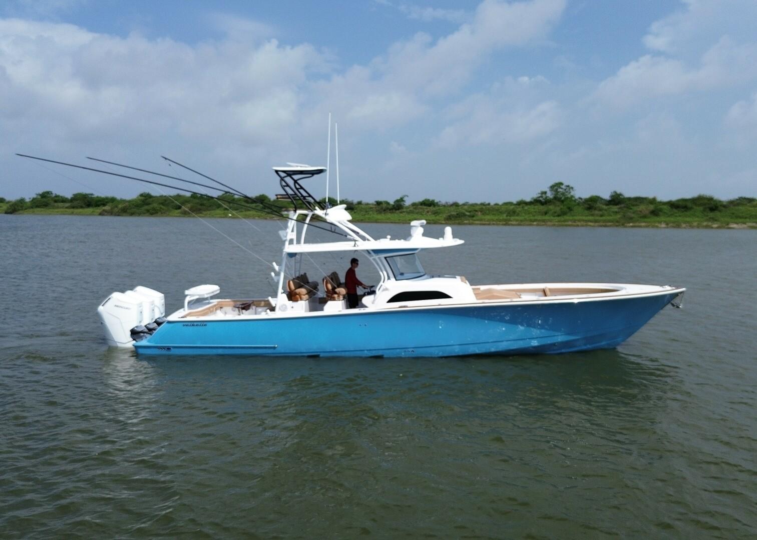 Valhalla Boatworks V46 2024 Valhalla Boatworks V46 in blue on calm water, side view.