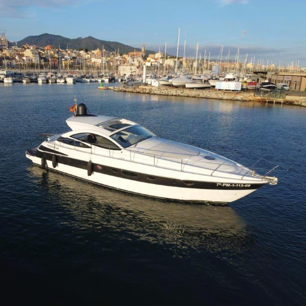 Pershing 46 2006 Pershing 46 yacht cruising in a marina with cityscape background.