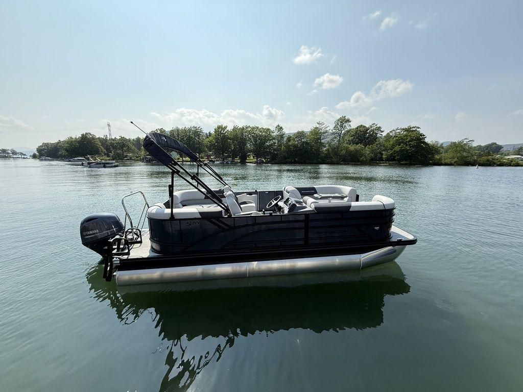 Bennington S Quad Bench 20 SSR 2026 Bennington S Quad Bench 20 SSR pontoon boat on a serene lake.