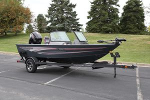 Ranger VS1682SC Angler 2024 Ranger VS1682SC Angler boat on trailer, parked outdoors with trees in background.