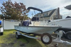 Boston Whaler 150 Montauk 2019 Boston Whaler 150 Montauk boat on trailer, parked in residential area.