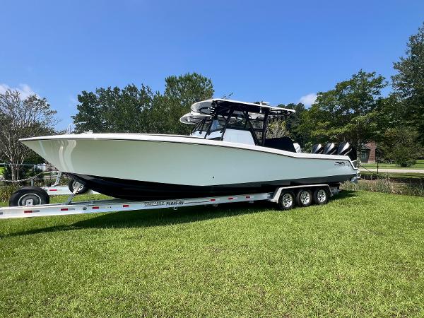 Invincible 36 Open Fisherman 2020 Invincible 36 Open Fisherman boat on trailer, parked on grass.